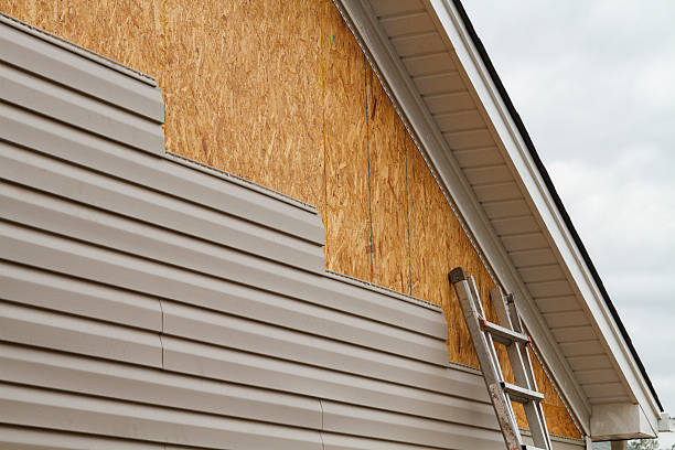 Professional Storm Damage Siding Repair technician working in Marshall, IL